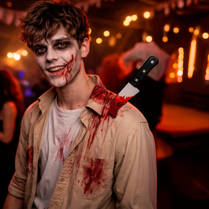 Halloween-falsk kniv i skulderen